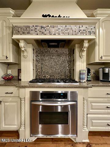 139 Glen Auburn Dr, Clinton, MS 39056 - kitchen featuring stainless steel oven, gas cooktop, tasteful backsplash, and stone countertops