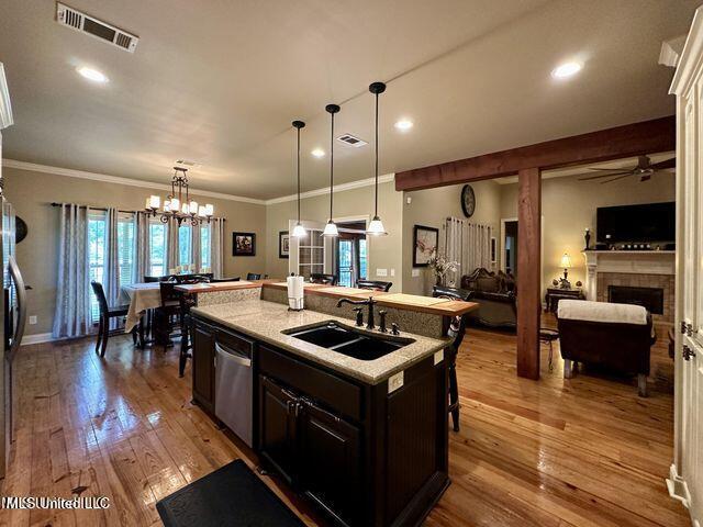 139 Glen Auburn Dr, Clinton, MS 39056 - kitchen featuring a sink, dishwasher, a ceiling fan, crown molding, and light wood-style flooring