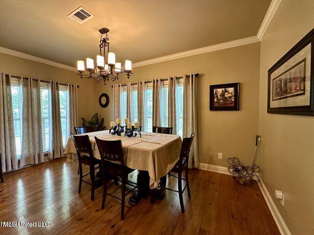 139 Glen Auburn Dr, Clinton, MS 39056 - dining space with baseboards, a chandelier, dark wood-style flooring, and ornamental molding
