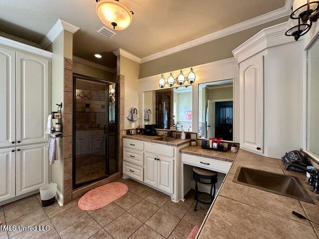 139 Glen Auburn Dr, Clinton, MS 39056 - bathroom with crown molding, vanity, a stall shower, and tile patterned floors