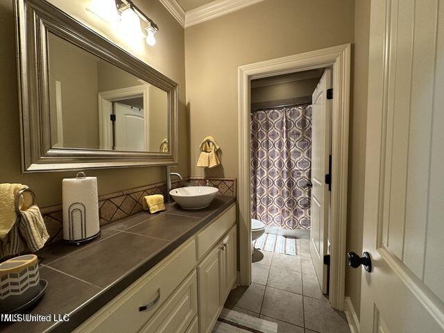 139 Glen Auburn Dr, Clinton, MS 39056 - full bath featuring ornamental molding, toilet, vanity, a shower with shower curtain, and tile patterned flooring