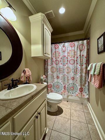 139 Glen Auburn Dr, Clinton, MS 39056 - bathroom featuring ornamental molding, toilet, vanity, tile patterned flooring, and curtained shower