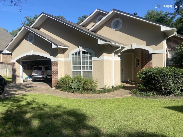 view of front of property featuring driveway, stucco siding, brick siding, and a garage