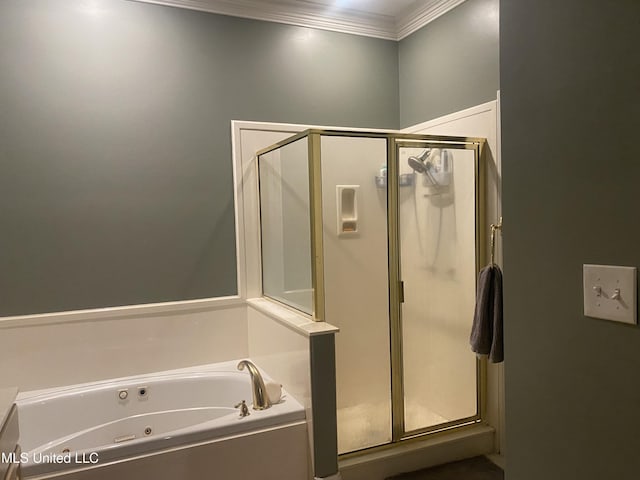 bathroom featuring a shower stall, crown molding, and a whirlpool tub