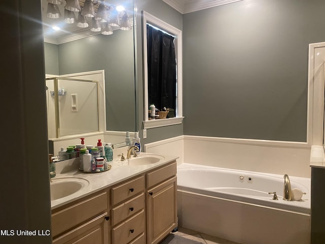 bathroom featuring ornamental molding, a garden tub, double vanity, and a sink