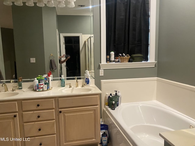 bathroom featuring a sink, double vanity, a garden tub, and visible vents
