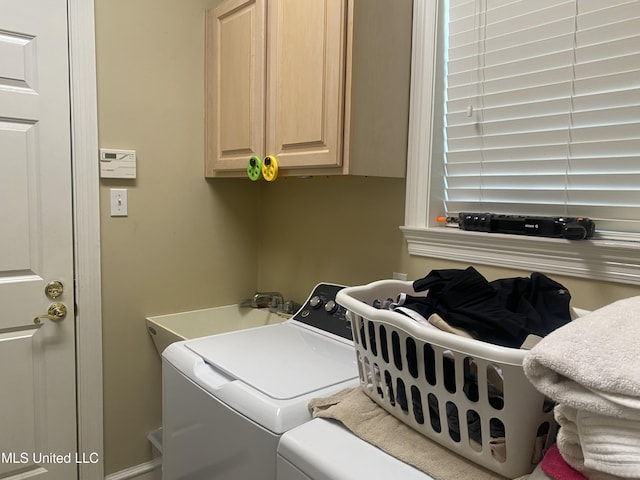 laundry area with a sink, cabinet space, and independent washer and dryer