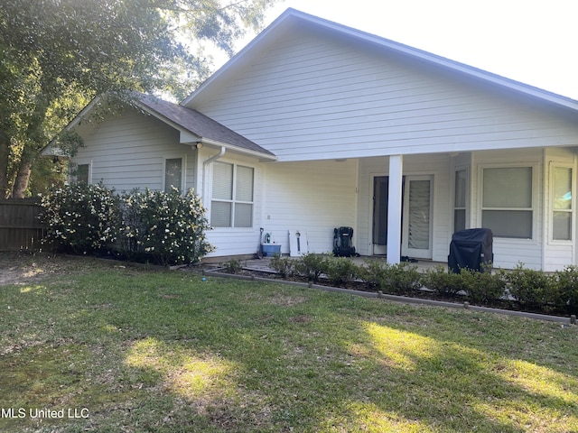 view of front of property with a front yard, a porch, and fence