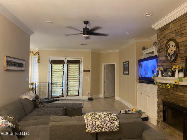 living area with baseboards, ceiling fan, light tile patterned flooring, crown molding, and a fireplace