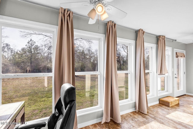 sunroom / solarium with a ceiling fan