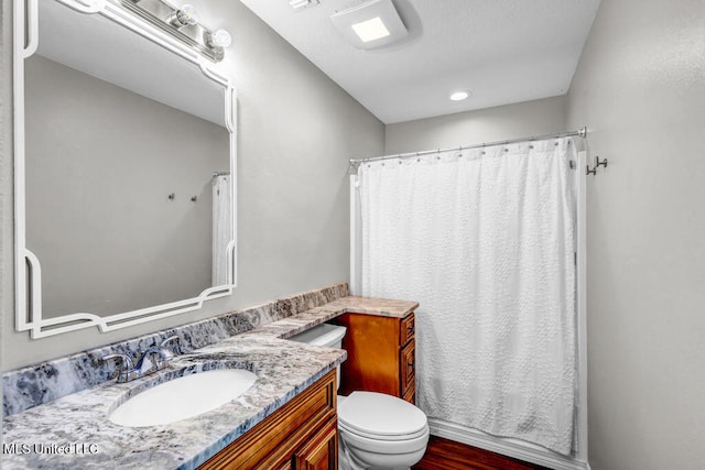 full bath featuring curtained shower, vanity, toilet, and wood finished floors