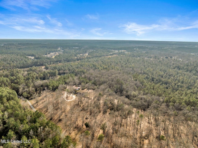 aerial view featuring a wooded view