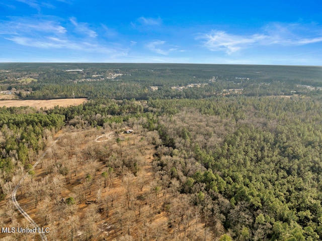 drone / aerial view featuring a view of trees