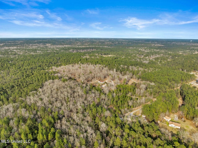 drone / aerial view featuring a view of trees