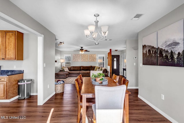 dining area featuring baseboards, visible vents, and dark wood finished floors