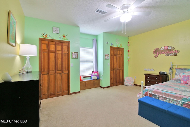 carpeted bedroom with a textured ceiling and ceiling fan