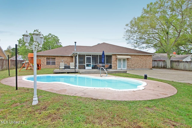 view of pool featuring a patio, a playground, and a yard