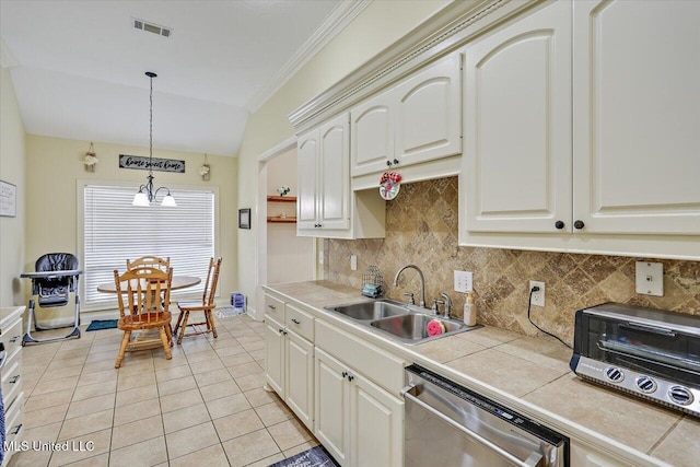 kitchen featuring a sink, visible vents, tile countertops, dishwasher, and lofted ceiling