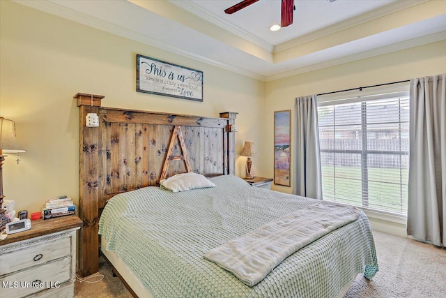carpeted bedroom with crown molding, recessed lighting, a ceiling fan, and a tray ceiling