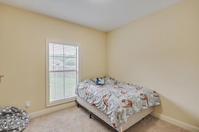 bedroom with carpet and baseboards