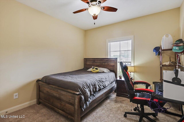 carpeted bedroom with a ceiling fan and baseboards