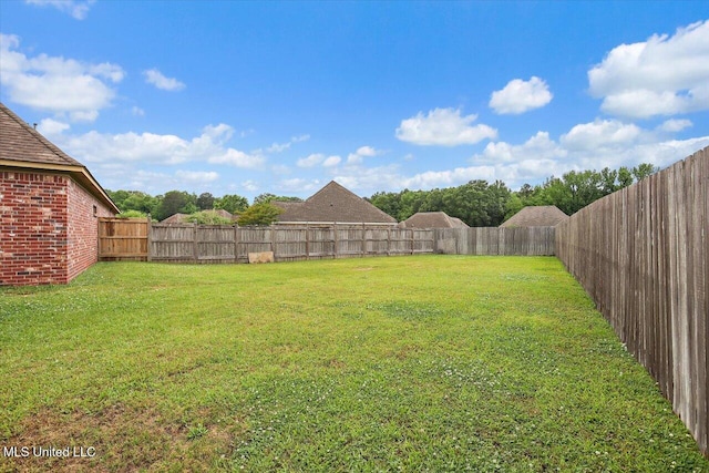 view of yard with a fenced backyard