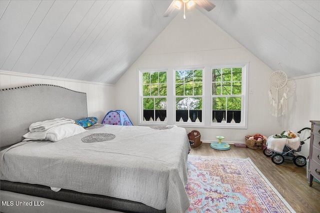 bedroom featuring ceiling fan, wood-type flooring, and lofted ceiling