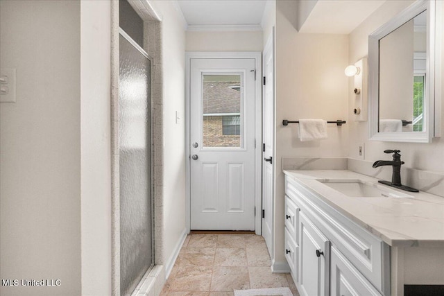 bathroom featuring plenty of natural light, a shower with shower door, and vanity