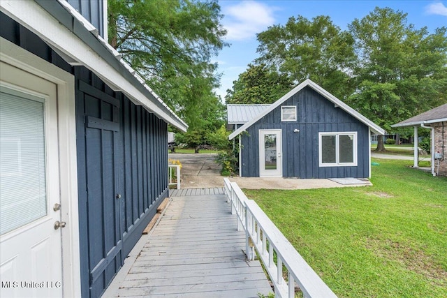 exterior space featuring an outdoor structure and a lawn