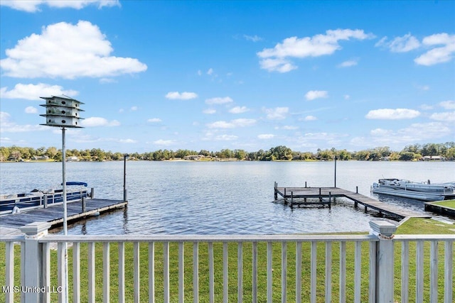 view of dock featuring a water view and a lawn