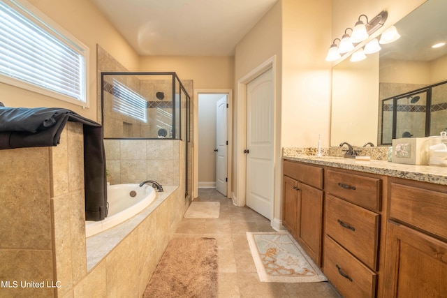 full bath featuring tile patterned floors, a garden tub, vanity, and a stall shower