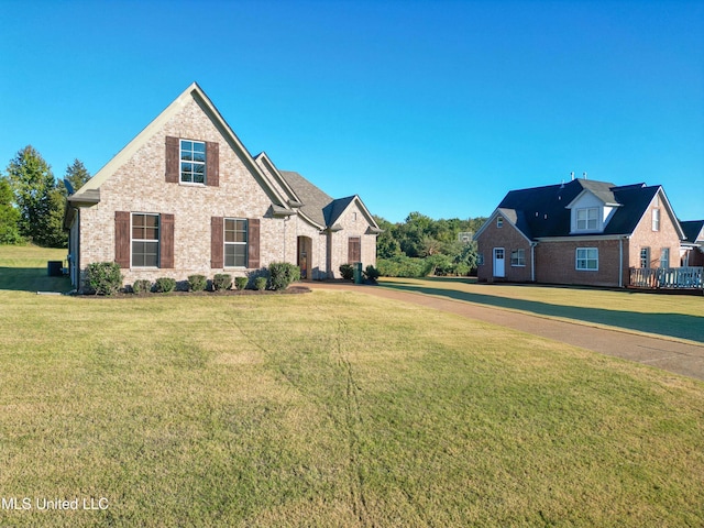 view of front of house featuring a front yard and brick siding