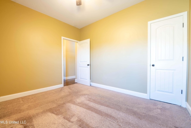carpeted spare room with baseboards