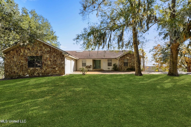 view of front of property with a garage and a front yard