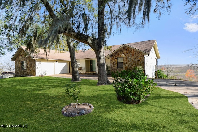 ranch-style home with a garage and a front lawn