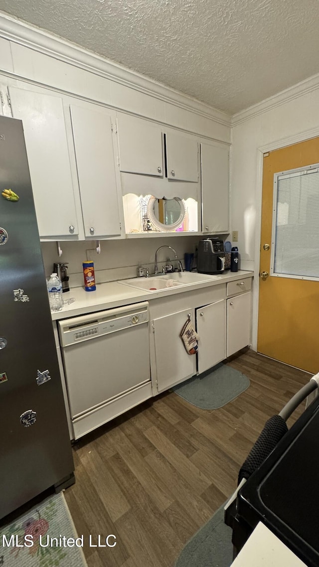 211 Boyd St, Ridgeland, MS 39157 - kitchen with white dishwasher, dark wood-style flooring, white cabinets, light countertops, and ornamental molding