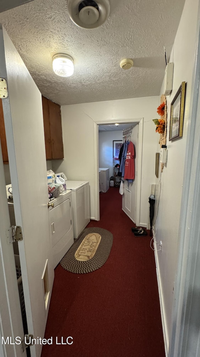211 Boyd St, Ridgeland, MS 39157 - laundry area featuring washer and clothes dryer, cabinet space, dark carpet, and a textured ceiling