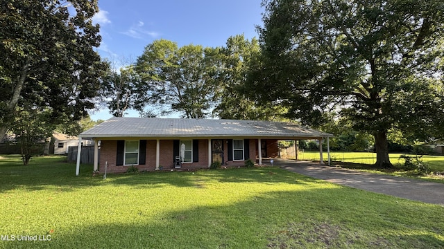 211 Boyd St, Ridgeland, MS 39157 - view of front of house featuring driveway, a front yard, brick siding, and a carport