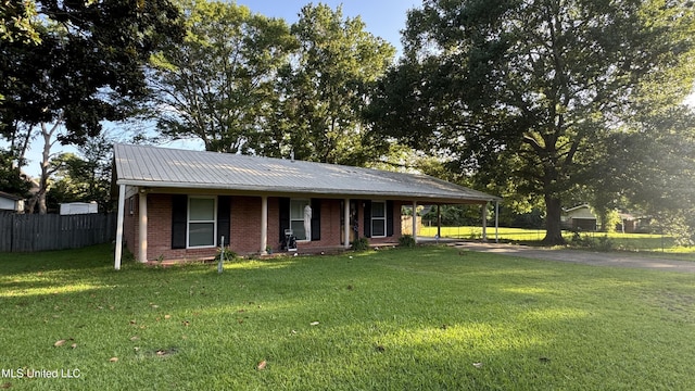 211 Boyd St, Ridgeland, MS 39157 - view of front of property featuring driveway, brick siding, an attached carport, a porch, and a metal roof