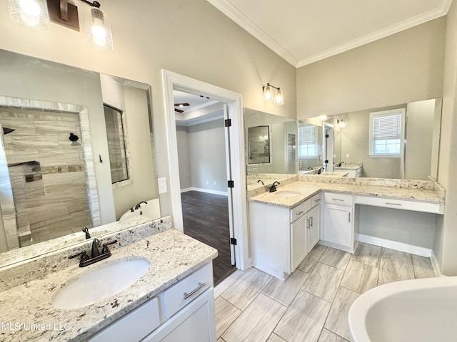 3464 Delaney Dr, Nesbit, MS 38651 - bathroom with crown molding, tiled shower, two vanities, and baseboards