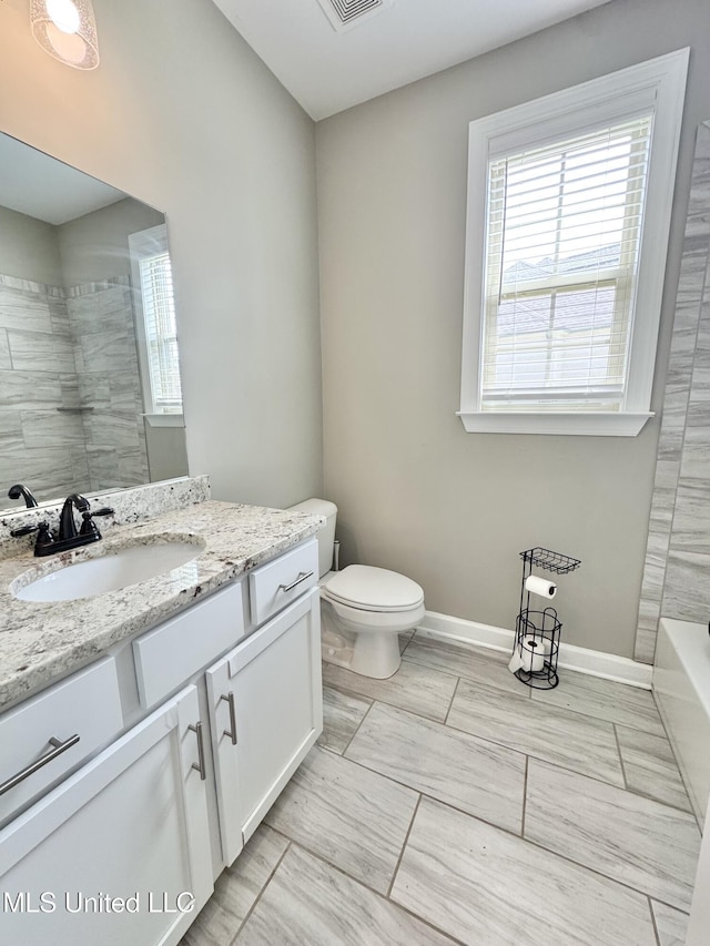 3464 Delaney Dr, Nesbit, MS 38651 - bathroom with healthy amount of natural light, vanity, toilet, and baseboards