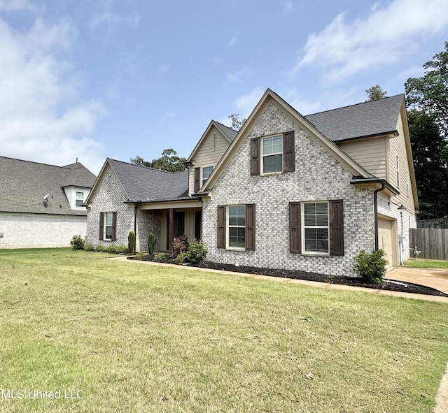 3464 Delaney Dr, Nesbit, MS 38651 - view of front of house with brick siding, a front yard, and roof with shingles