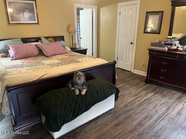 bedroom featuring dark hardwood / wood-style flooring