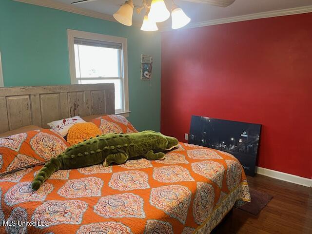 715 Sumner Ave, Greenwood, MS 38930 - bedroom with wood finished floors, crown molding, and ceiling fan