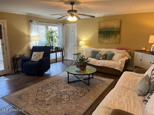 living room featuring ceiling fan, dark hardwood / wood-style flooring, and ornamental molding