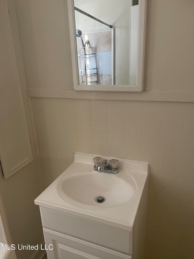 bathroom featuring tile walls and vanity