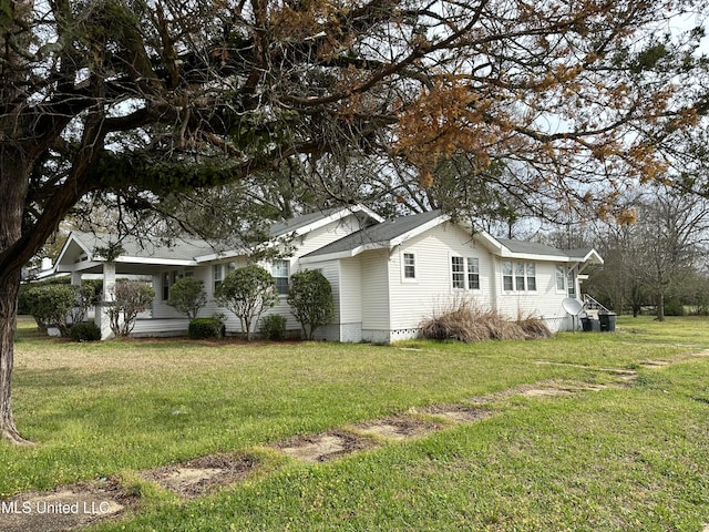 view of side of home with a lawn