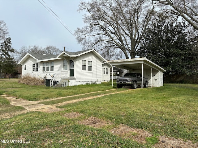 view of side of home featuring a lawn and a carport