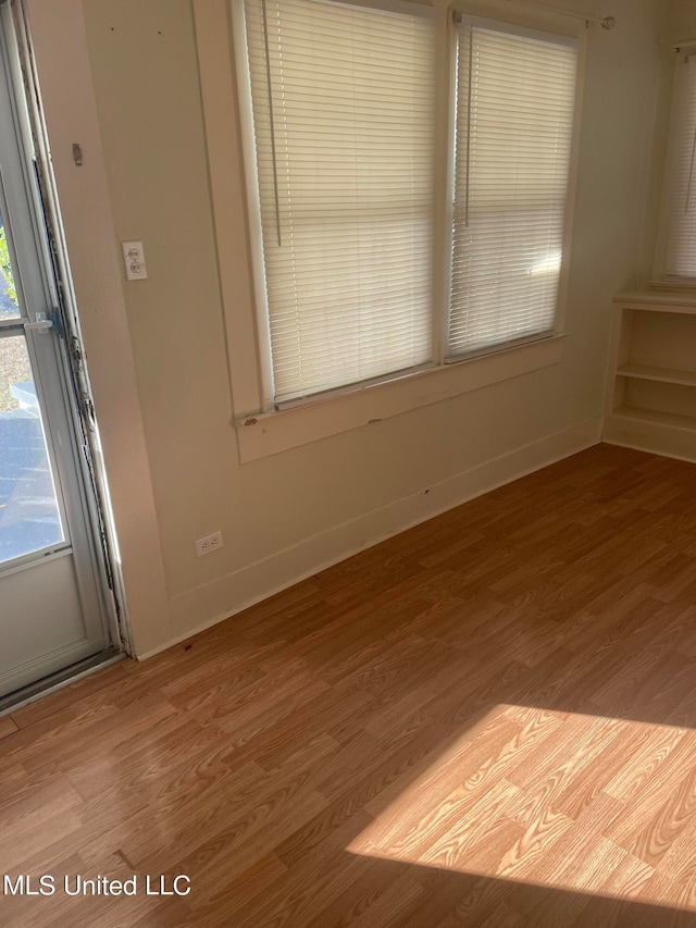 unfurnished room featuring hardwood / wood-style floors