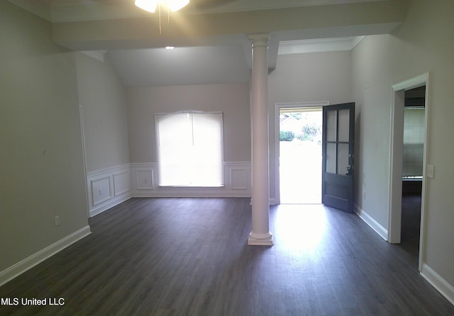 spare room featuring dark hardwood / wood-style floors, ornate columns, and ceiling fan